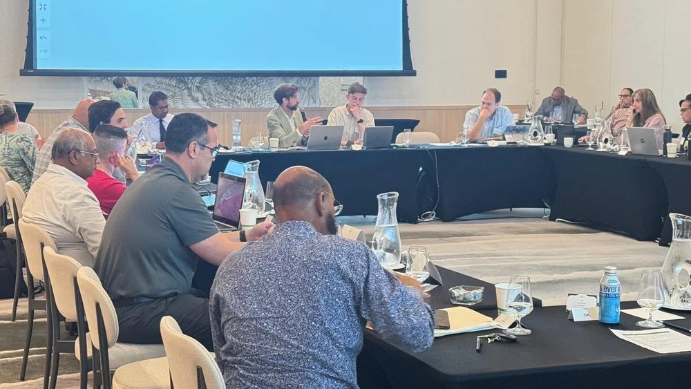 Sam DB speaking at a private summit in the Cayman Islands